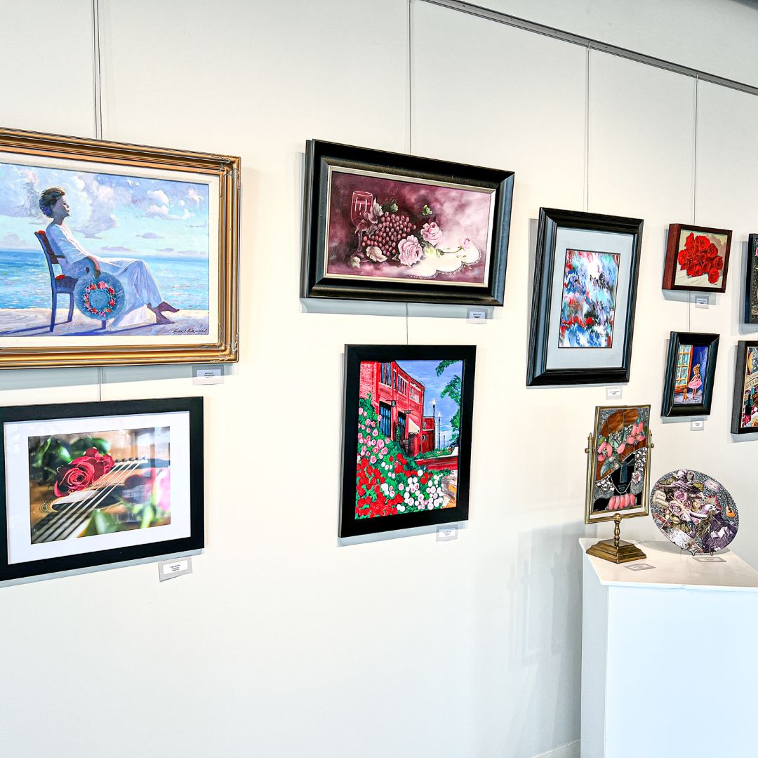 A white gallery wall displaying 12 medium-sized art pieces.